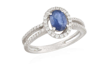 Description A SAPPHIRE AND DIAMOND RING, the oval-shaped sapphire...