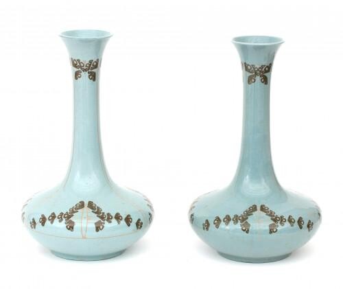 A pair of blue glazed ceramic vases decorated with stylized floral pattern in green and pink, both signed with stamped manufacturer's mark underneath, painter's initials, one numbered 141. (2)