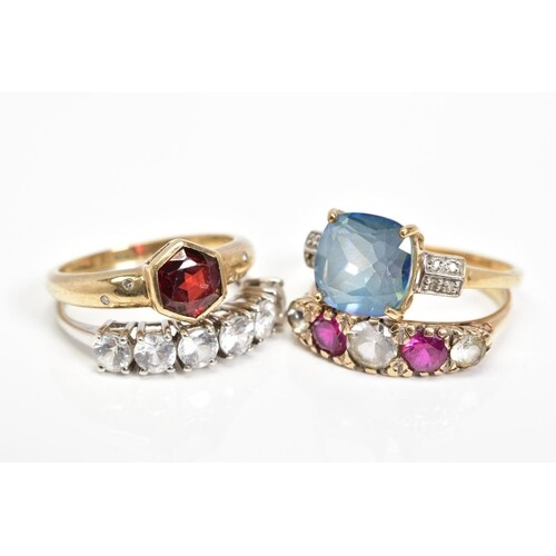 FOUR 9CT GOLD GEM SET RINGS, the first collet set with a cen...