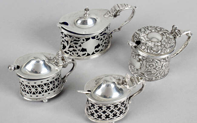Four early 20th century silver mustard pots, three pierced and one with embossed decoration. (4).