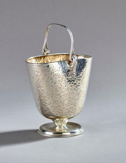 Hammered silver basket-shaped cooler. Pedestal underlined with gadroons.