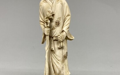 JAPON, c. 1930/1940. Okimono en ivoire sculpté, représentant un homme debout tenant un bâton, un...