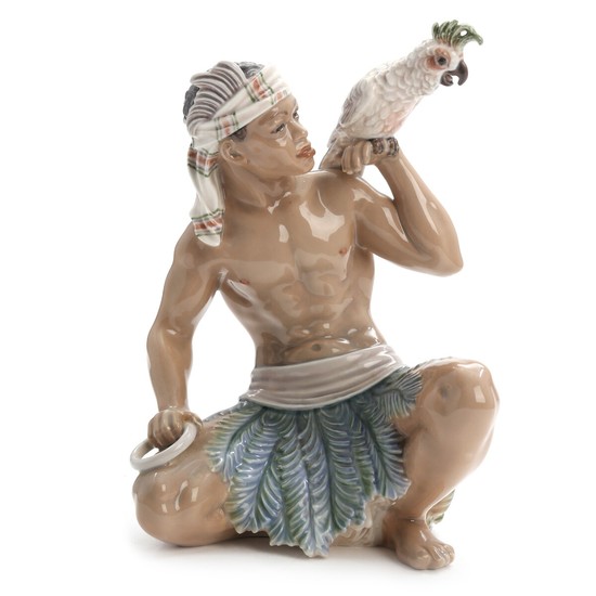Jens Peter Dahl-Jensen: “Sudanese man with cockatoo”. A Dahl-Jensen porcelain figurine, decorated in underglaze colours. No. 1305. H. 24 cm.