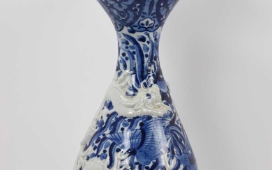 Large late 19th century Japanese blue and white porcelain vase, moulded and painted in underglaze blue with dragons, shaped rim, 55cm high