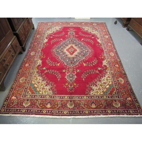 Middle Eastern design Tabriz carpet on a red ground, the bor...