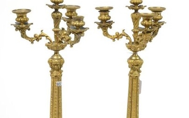 Pair of large Restoration style tripod candelabra in gilt bronze with three fluted shaft light arms and "Mascarons". Period: 19th century. (One bobeche is missing). H.:+/-55,3cm.
