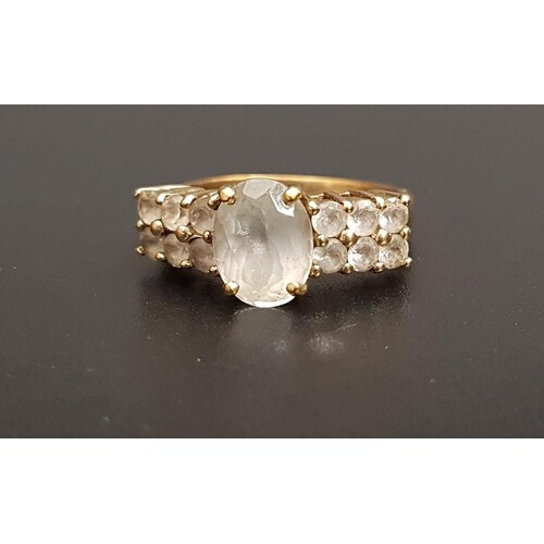 QUARTZ DRESS RING the central oval cut gemstone flanked by t...