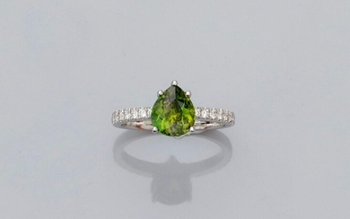 Ring in white gold, 750 MM, set with a pretty pear cut green tourmaline weighing about 1.70 carat between two lines of brilliants, size: 51/52, weight: 3.2gr. gross.