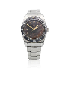 Rolex. A stainless steel automatic bracelet watch with tropical gilt dial