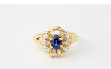 Sapphire and Diamond Ring An oval-shaped sapphire to cent...