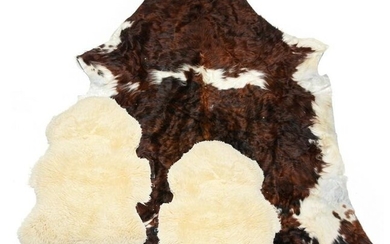 TWO LAMB SKINS AND A COW HIDE.