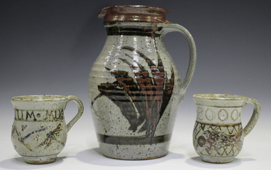 Two Elizabeth Roussel studio pottery mugs, both commemorating the millennium, height 9.3cm, together