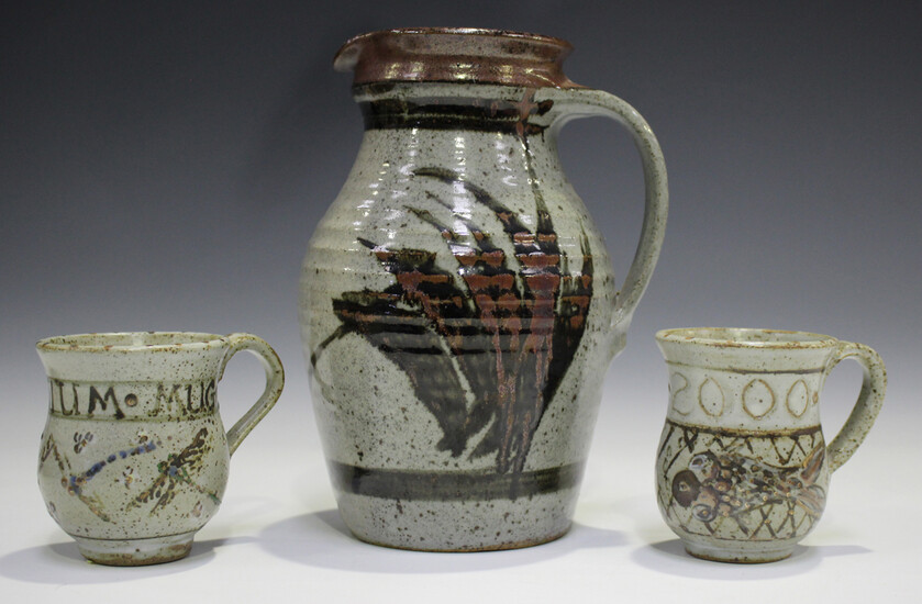 Two Elizabeth Roussel studio pottery mugs, both commemorating the millennium, height 9.3cm, together