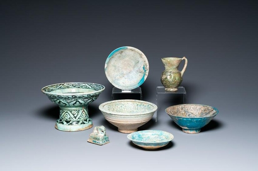 Two turquoise- and black-glazed dishes, three bowls, a jug and a small lion, Raqqa and Nishapur