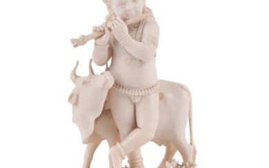 Y An Indian carved ivory figure of the infant Krishna playing the flute
