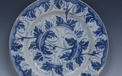 An English Delft circular plate, decorated in