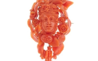 A late Victorian coral brooch. Carved to depict the