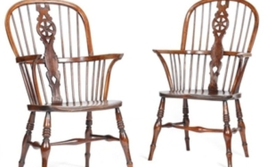 A matched pair of yew high back Windsor armchairs …