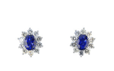 A pair of sapphire and diamond cluster earrings. View more details