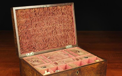 A 19th Century Amboyna Veneered Work Box of rectangular form. The hinged lid opening to reveal a fad