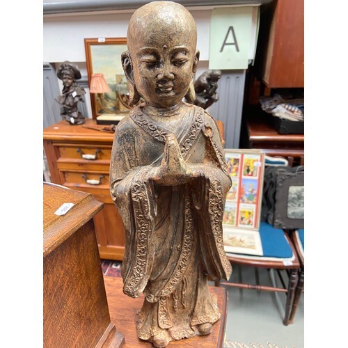 A 19th century Chinese cast iron Monk figure.Showing signs o...