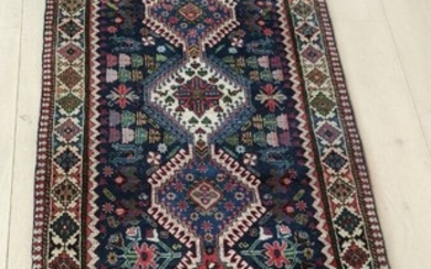 A 21st century Persian Yalameh carpet. Design with connected medallions upon blue background with stylized flowers etc. 235×71 cm.