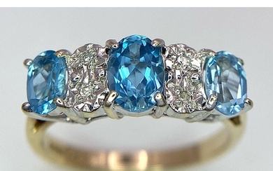 A 9K Yellow Gold Diamond and London Blue Topaz Ring. Size J,...