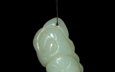 A Chinese carved jade 'fish' and 'lotus' pendant, 19th century