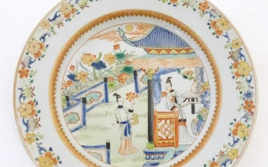 A Chinese plate depicting two ladies in a garden