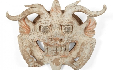 A Chinese terracotta mask with the face of a threatening...