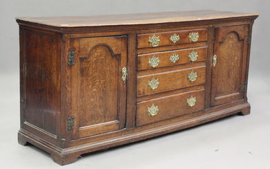 A George III oak dresser base, fitted with four drawers, flanked by arched panel doors, height 80cm