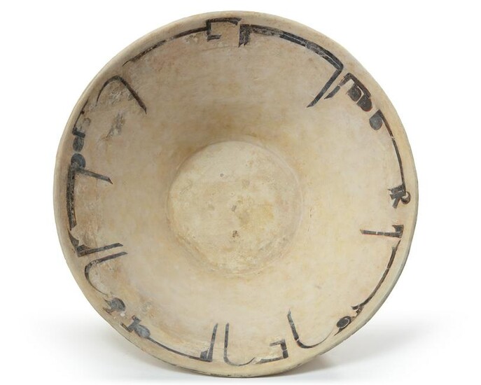 A NISHAPUR CALLIGRAPHIC SLIP-PAINTED POTTERY BOWL