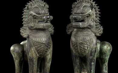 A PAIR OF BRONZE KHMER STYLE BUDDHIST LIONS Cambodia