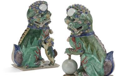 A PAIR OF CHINESE FAMILLE VERTE BISCUIT PORCELAIN BUDDHIST LIONS
