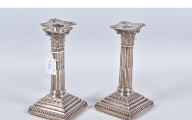 A PAIR OF LATE VICTORIAN SILVER CANDLE STICKS, Corinthian co...