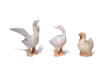 A PAIR OF PAINTED POTTERY MODELS OF GEESE AND A...