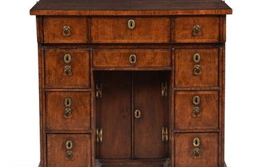 A QUEEN ANNE WALNUT AND FEATHERBANDED KNEEHOLE DESK, CIRCA 1710