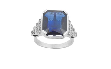 A Synthetic Sapphire and Diamond Ring the emerald-cut synthetic sapphire...