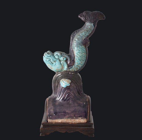 A TURQUOISE & AUBERGINE ROOF-TILE DEPICTING A FIGURE OF A LEAPING FISH - Pottery - China - Ming Dynasty (1368-1644)