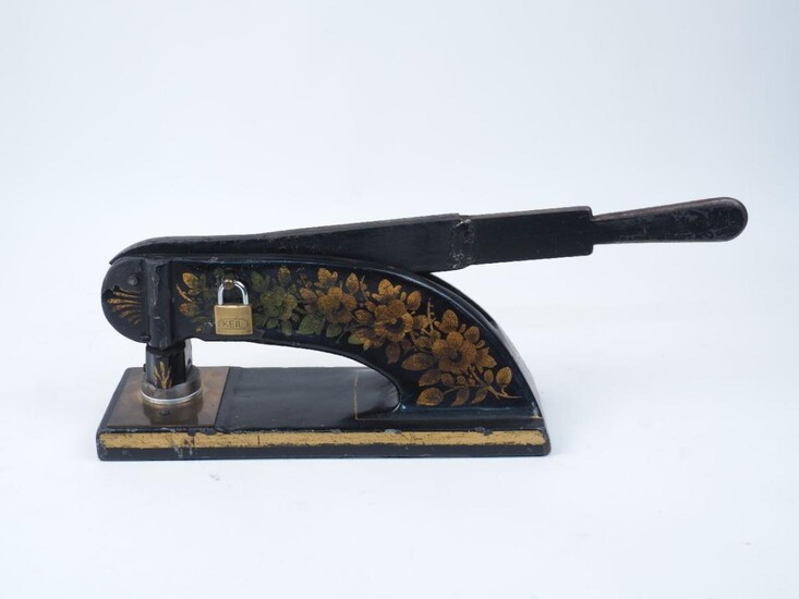 A Victorian embossing press for company seals, late 19th century, cast iron with japanned decoration and brass mounts, with modern lock attached, lacking key, 54cm long, 19cm high
