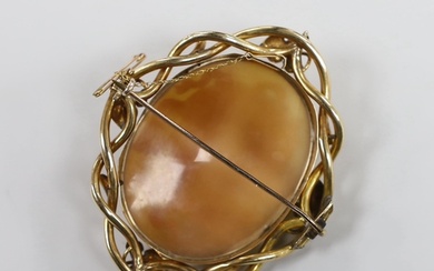 A Victorian yellow metal mounted oval cameo shell brooch, ca...
