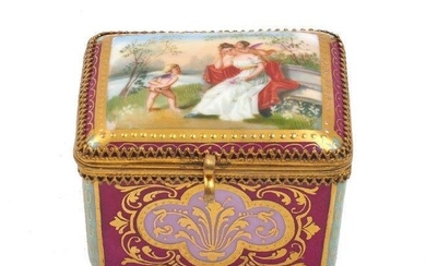 A Vienna porcelain and ormolu mounted box, late 19th / early 20th century, the exterior panels of red ground with pink cartouche and gilt highlights, separated by green corner panels, the lid decorated with a pastoral scene of a lady with cherubs...