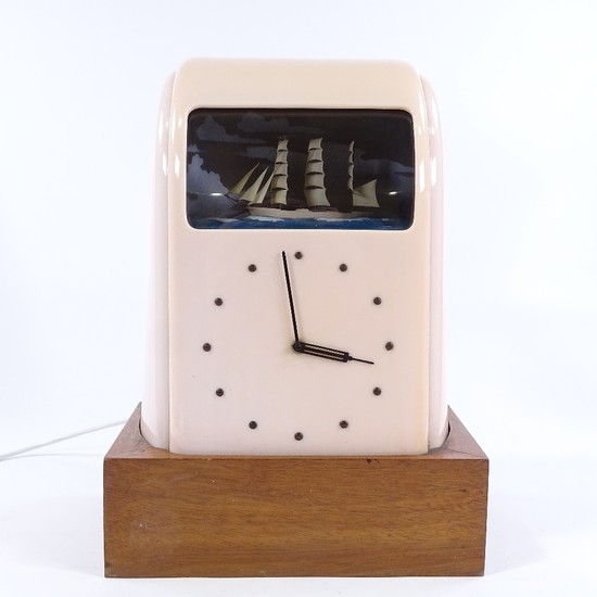 A Vitascope pink Bakelite-cased clock, circa 1930s, with rol...