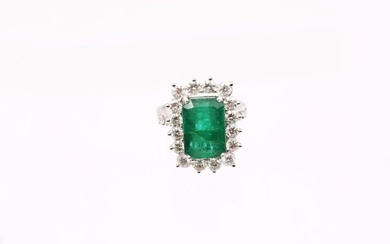 A Zambian emerald and diamond 18ct gold cluster ring, comprising...