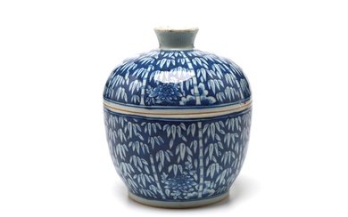 A blue and white porcelain covered jar painted with bamboo branches on a blue ground