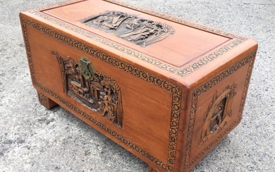 A carved camphorwood chest, the rectangular top with figures and...
