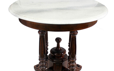 A carved teak round table with marble top
