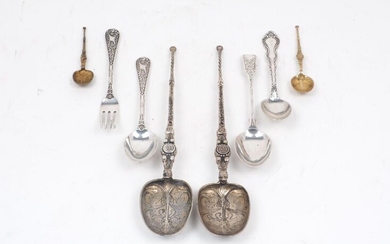 A collection of silver spoons, to include a pair of...