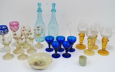 A collection of various drinking glasses and table wares, 20th century, to include: a set of four roemer wine glasses, the clear bowls with etched grape and vine decoration atop orange graduating knopped and prunted stems, each 18.8cm high; a set...