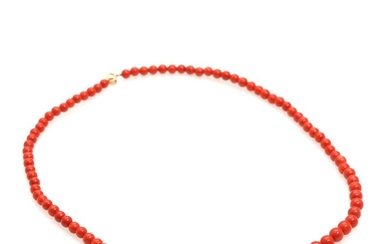 A coral necklace set with numerous polished corals and three 10k gold...